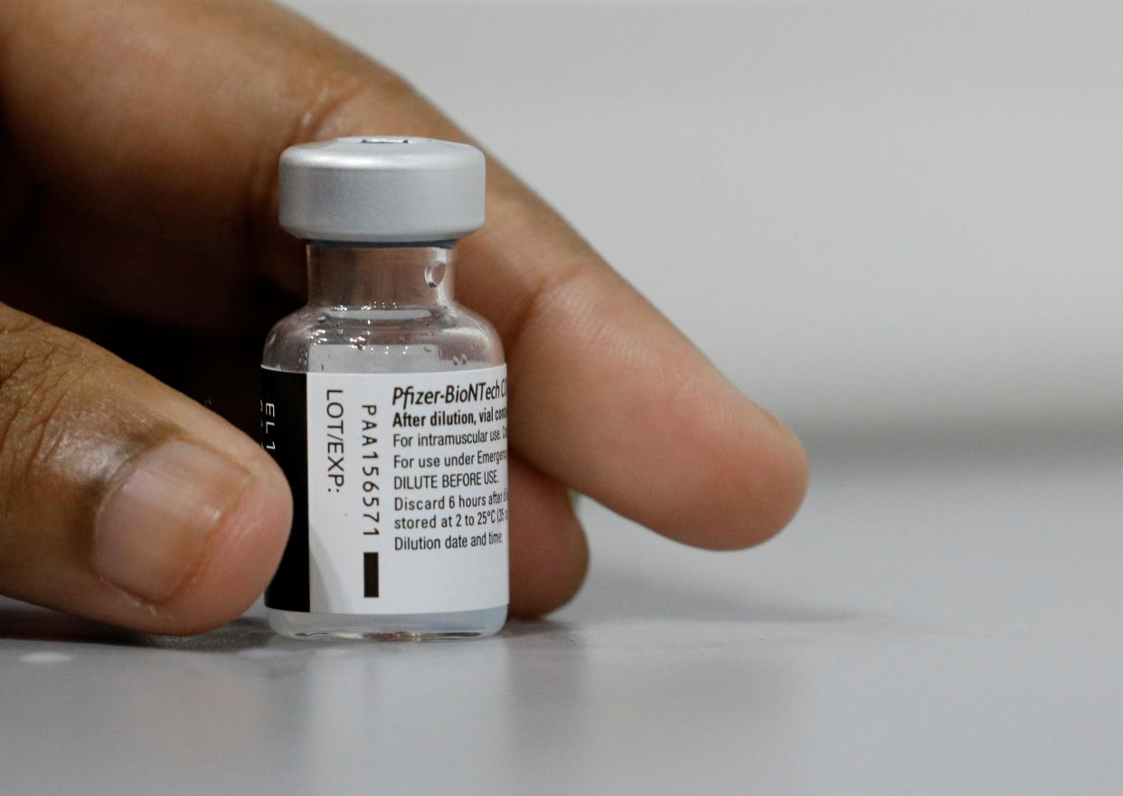 A medical worker prepares to dilute a vial of Pfizer-BioNTech vaccine at a coronavirus disease (COVID-19) vaccination center in Singapore March 8, 2021. REUTERS/Edgar Su