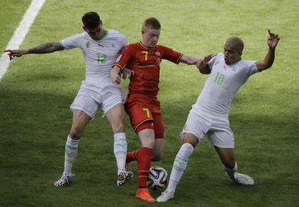 Algeria&#39;s Carl Medjani (L), Belgium&#39;s Kevin De Bruyne and Algeria&#39;s Sofiane Feghouli fight for the ball. (AP)