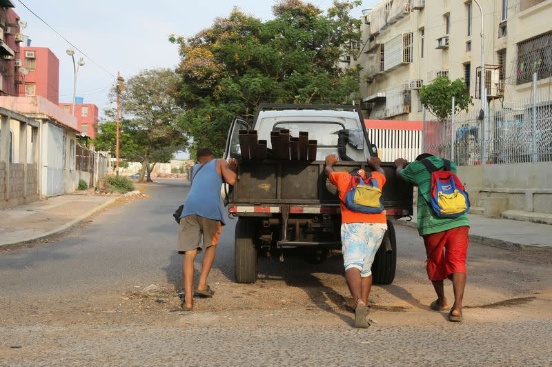 Men push a truck that run out of fuel as Venezuelans are struggling to cope with chronic fuel shortage, in Maracaibo