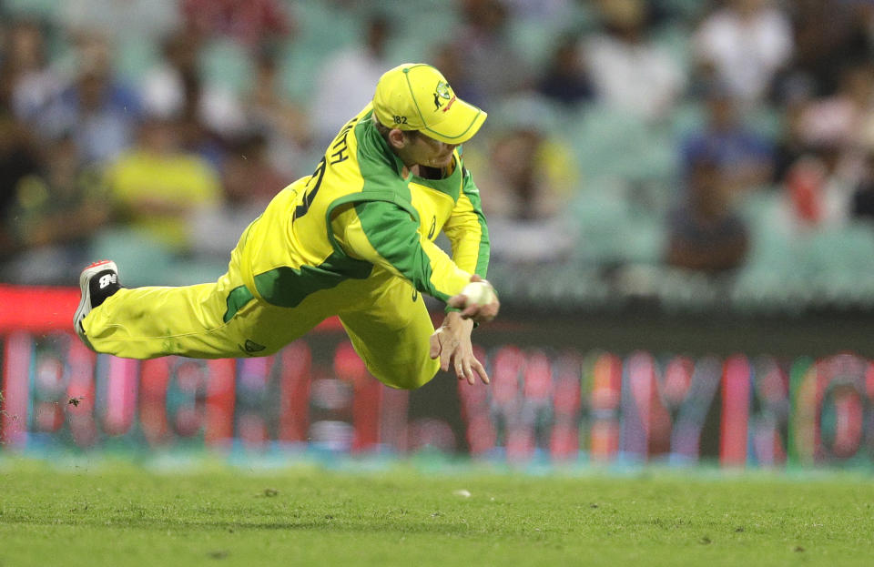 Australia's Steve Smith dives to field the ball during the one day international cricket match between India and Australia at the Sydney Cricket Ground in Sydney, Australia, Friday, Nov. 27, 2020. (AP Photo/Rick Rycroft)