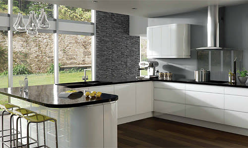 <b>Urban chic</b><br><br>This Integra Gloss White kitchen from Next is the ultimate in clean-line chic. The handless finger-pull doors keep the look streamlined, while reflective black worktops, glass splashblack and feature slate wall adds to the modern monochrome appeal. A group of glass pendants makes an interesting feature, as well as helping to keep the room light and bright.