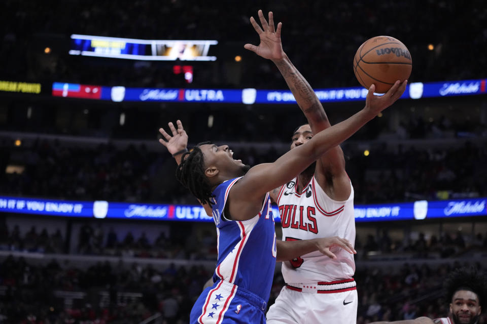 Philadelphia 76ers' Tyrese Maxey drives to the basket past Chicago Bulls' Derrick Jones Jr. during the first half of an NBA basketball game Wednesday, March 22, 2023, in Chicago. (AP Photo/Charles Rex Arbogast)