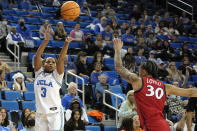 UCLA guard Londynn Jones, left, shoots as Arizona guard Jade Loville defends during the second half of an NCAA college basketball game Friday, Feb. 3, 2023, in Los Angeles. (AP Photo/Mark J. Terrill)