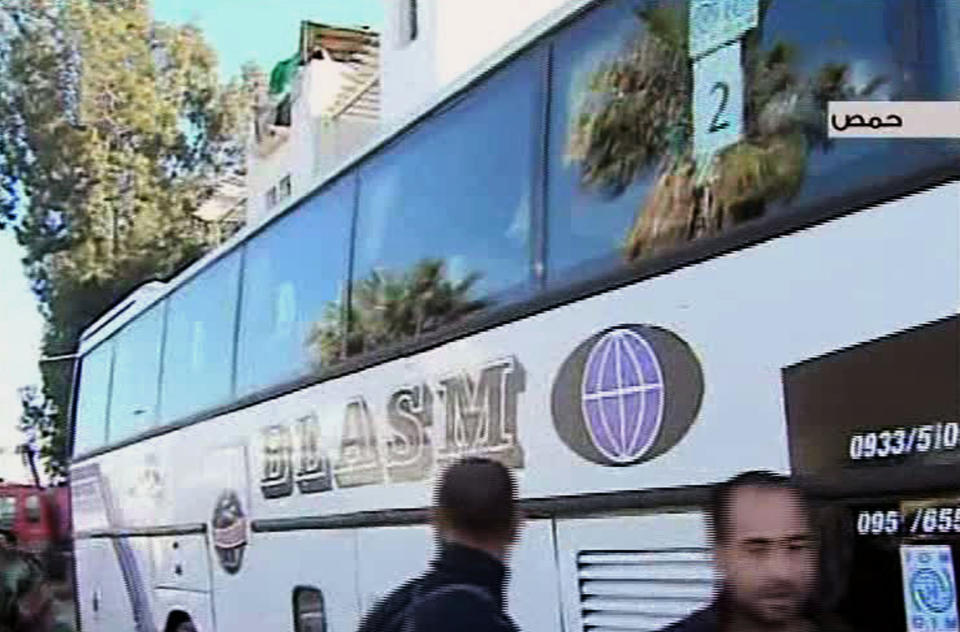 In this video image released by the Syrian official news agency SANA, Syrian citizens sit aboard a bus after they evacuated the besieged rebel-held neighborhood of of Jouret el-Shayah, in Homs province, Syria, Friday, Feb. 7, 2014. The Syrian government on Friday began evacuating civilians trapped in rebel-held parts of a battleground city under a rare deal struck between the government and the opposition that also included a three-day cease-fire allowing humanitarian aid convoys to the besieged areas. (AP Photo/SANA)