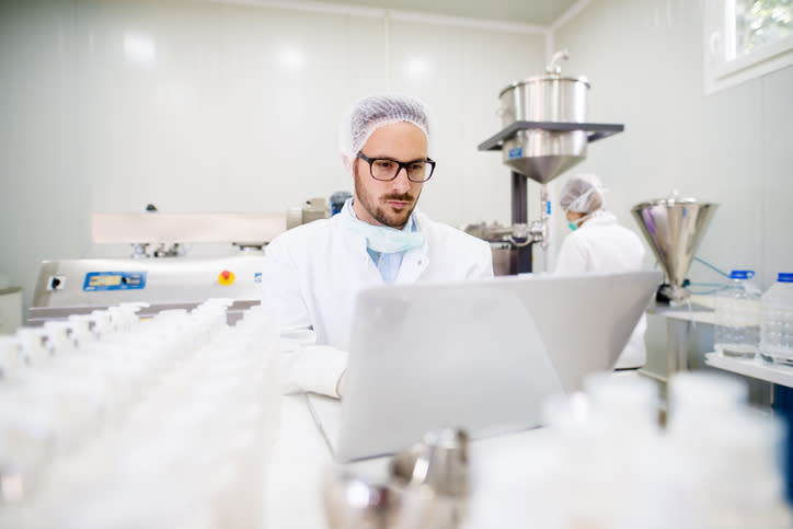 A technician in a drug manufacturing facility.