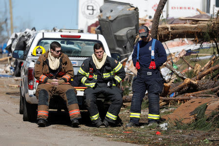 Members of the Auburn fire department are seen outside a devastated home after two deadly back-to-back tornadoes, in Beauregard, Alabama, U.S., March 5, 2019. REUTERS/Shannon Stapleton