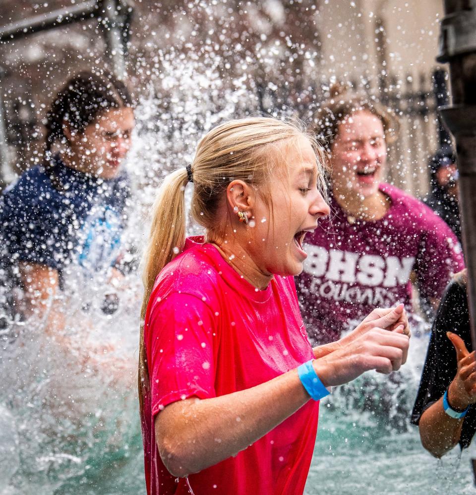 Bloomington North student Mia Robbennolt reacts to her jump into the cold water at the 2024 Polar Plunge benefitting Special Olympics Indiana at Memorial Stadium on Saturday, Feb. 24, 2024.