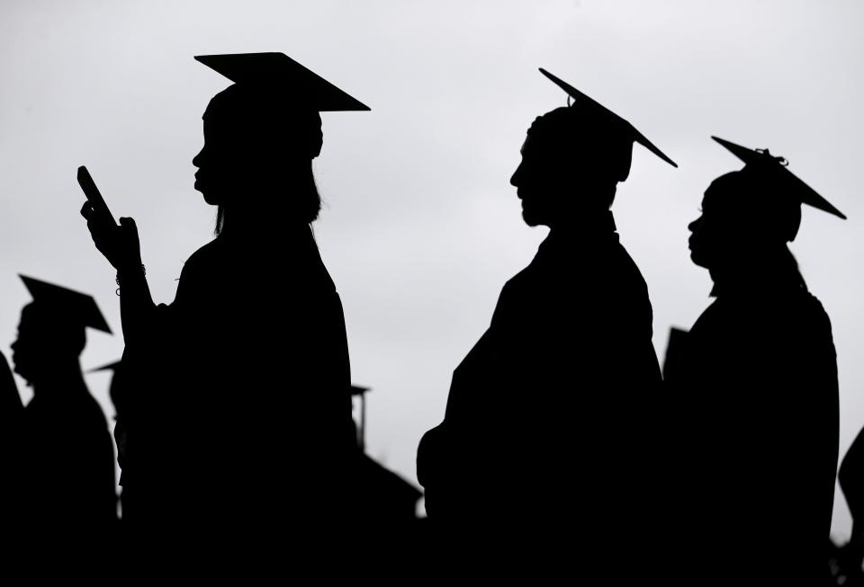 New graduates line up before the start of a community college commencement in East Rutherford, N.J., May 17, 2018.