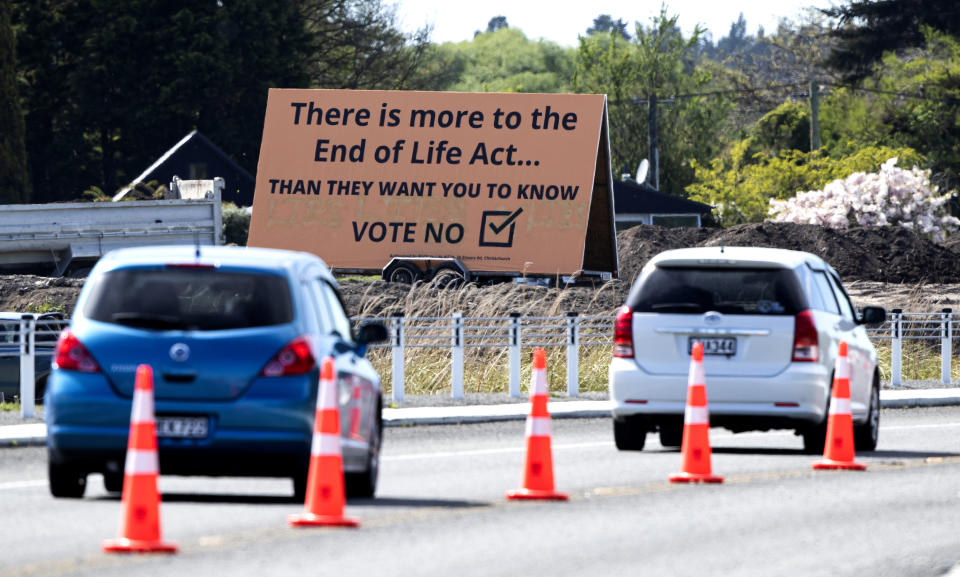 Cars are driven past a billboard urging voters to vote "No" against euthanasia in Christchurch, New Zealand, Friday, Oct. 16, 2020. New Zealanders are poised to decide on two crucial social issues during an election on Saturday, Oct. 17, whether to legalize recreational marijuana and whether to legalize euthanasia. (AP Photo/Mark Baker)