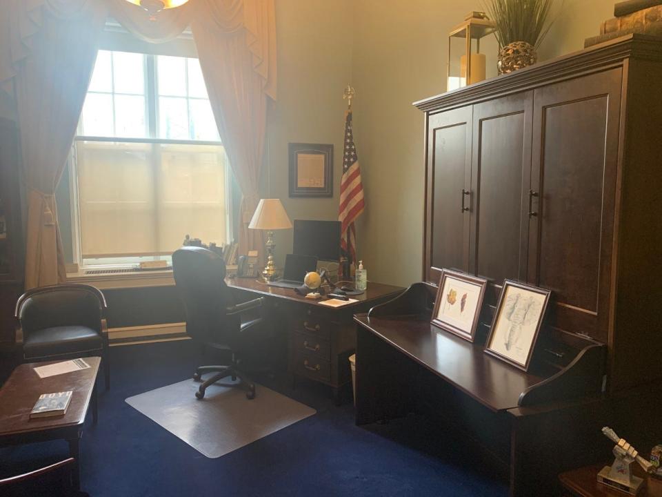 A photo of the mahogany cabinet in Rep.  Ted Budd's office that doubles as a Murphy bed. Budd is one of an estimated 100 lawmakers who sleep in their Capitol Hill offices when they are in Washington, D.C., a practice that is getting scrutiny amid the coronations