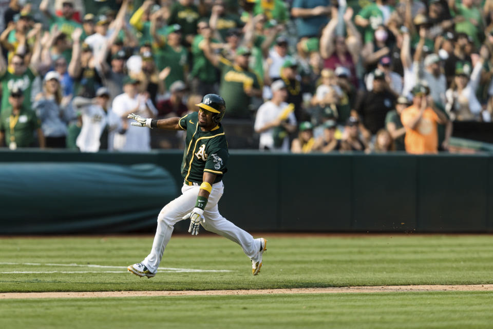 Oakland Athletics' Elvis Andrus runs home to score a walk-off win against the Houston Astros in the ninth inning of a baseball game in Oakland, Calif., Saturday, Sept. 25, 2021. The Athletics won 2-1. (AP Photo/John Hefti)