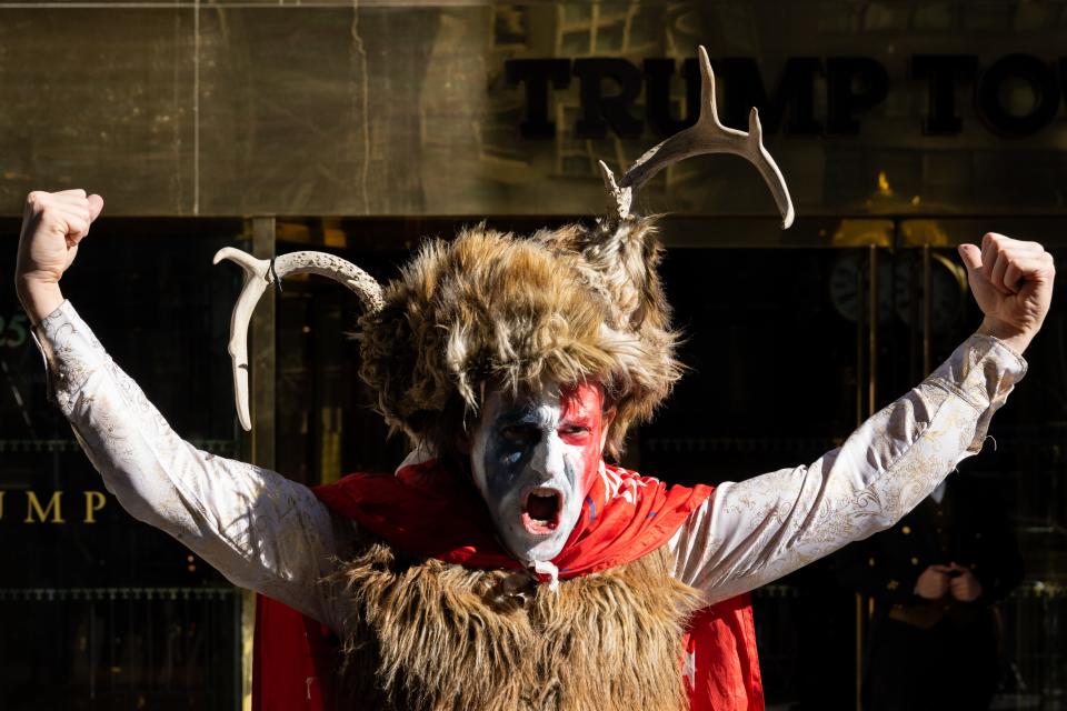 A demonstrator dressed like the Q-Anon Shaman is seen walking into Trump Tower (Getty Images)