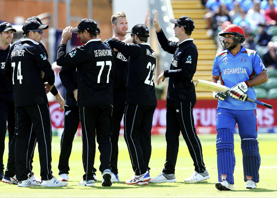 New Zealand's Martin Guptill celebrates taking the wicket of Afghanistan's Rahmat Shah during the ICC Cricket World Cup group stage match between Afghanistan and New Zealand at the County Ground Taunton, England, Saturday, June 8, 2019. (Mark Kerton/PA via AP)