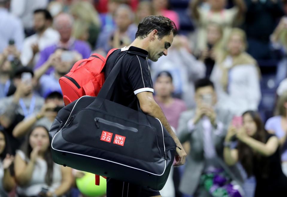 Roger Federer of Switzerland walks off the tennis court.