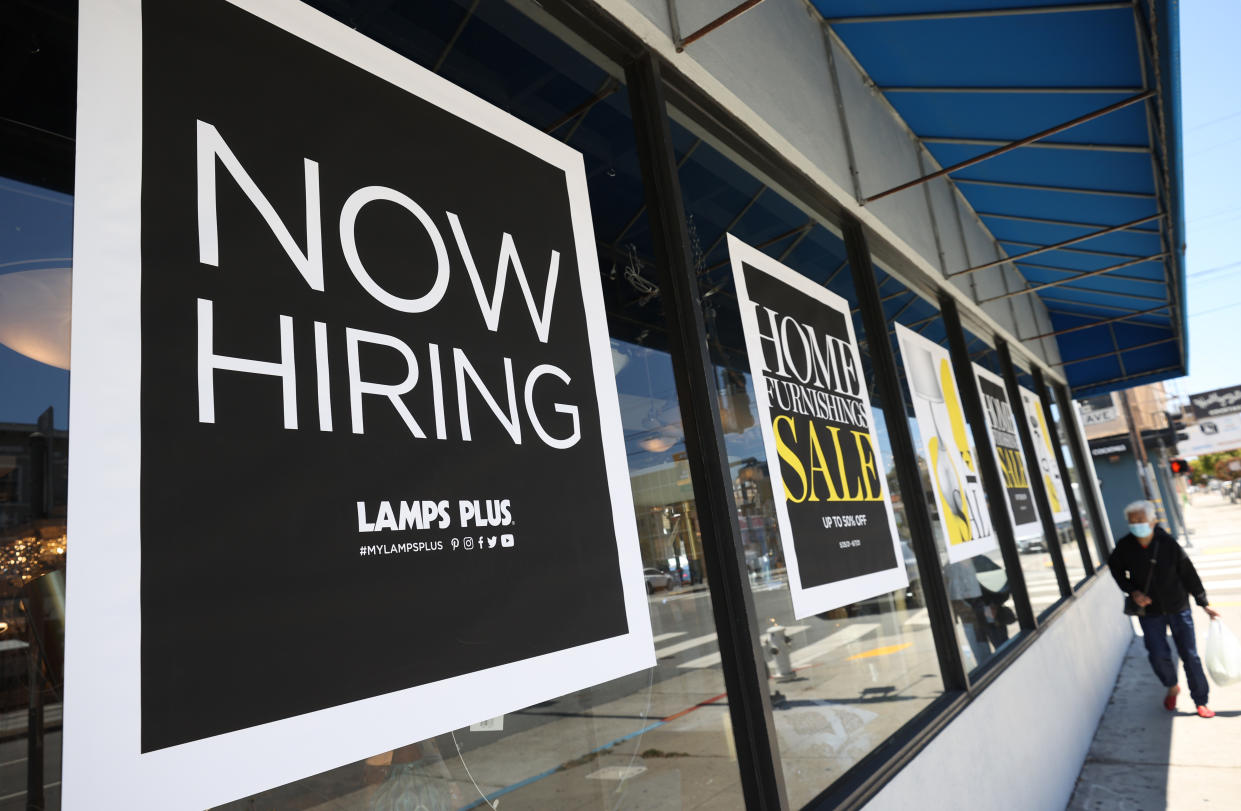 SAN FRANCISCO, CALIFORNIA - JUNE 03: A pedestrian walks by a Now Hiring sign outside of a Lamps Plus store on June 03, 2021 in San Francisco, California. According to a U.S. Labor Department report, jobless claims fell for a fifth straight week to 385,000. (Photo by Justin Sullivan/Getty Images)