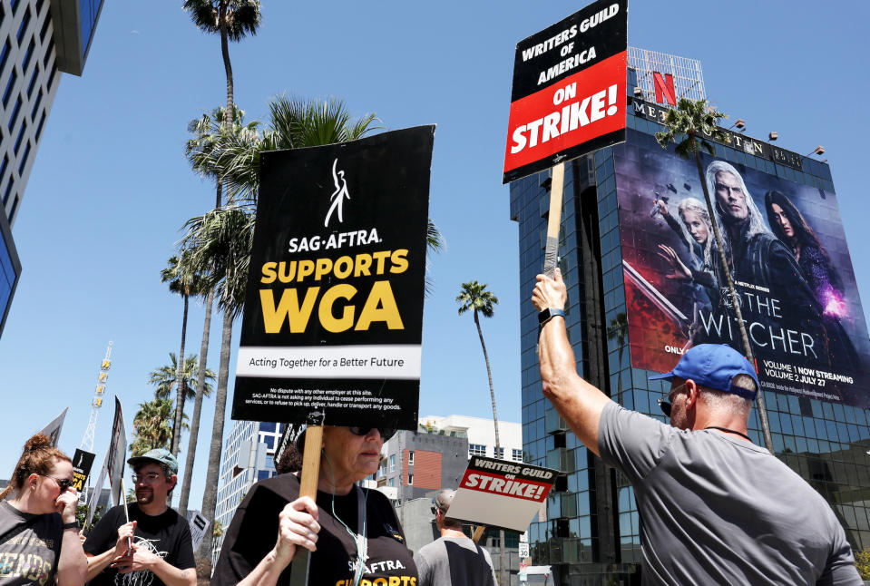 LOS ANGELES, CALIFORNIA - JULY 11: A sign reads 'SAG-AFTRA Supports WGA' as SAG-AFTRA members walk the picket line in solidarity with striking WGA (Writers Guild of America) workers outside Netflix offices on July 11, 2023 in Los Angeles, California. Industry insiders concerned about the possibility of a potential actors’ strike will have to wait a little bit longer to know for sure. SAG-AFTRA and top studios and streamers have agreed to extend their current contract negotiations until July 12 at 11:59 p.m. (Photo by Mario Tama/Getty Images)