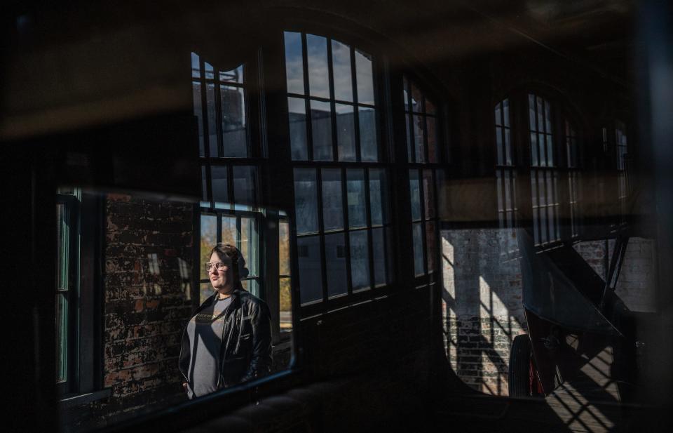 Detroit History Tours Executive Director Bailey Sisoy-Moore stands amongst vehicles on display at the Ford Piquette Plant in Detroit on October 28, 2020. Detroit History Tours held a Ghosts of the Factory Tour and Paranormal Investigation at the historic plant turned museum.