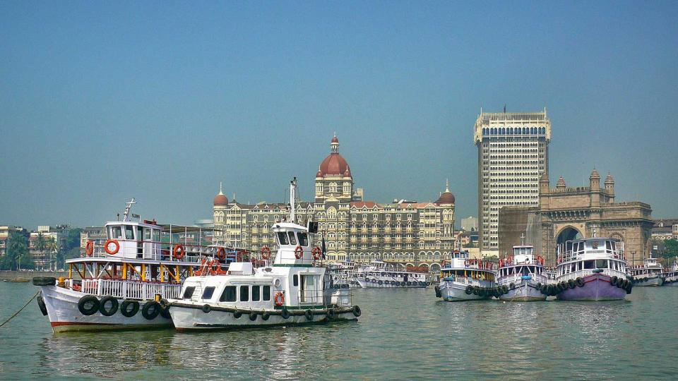 Panoramic view of  Weelington Harbor (former Apollo Bunder) with the Gate of India, Taj Mahal Palace and the Tower in the background in Mumbai, Maharashtra, India