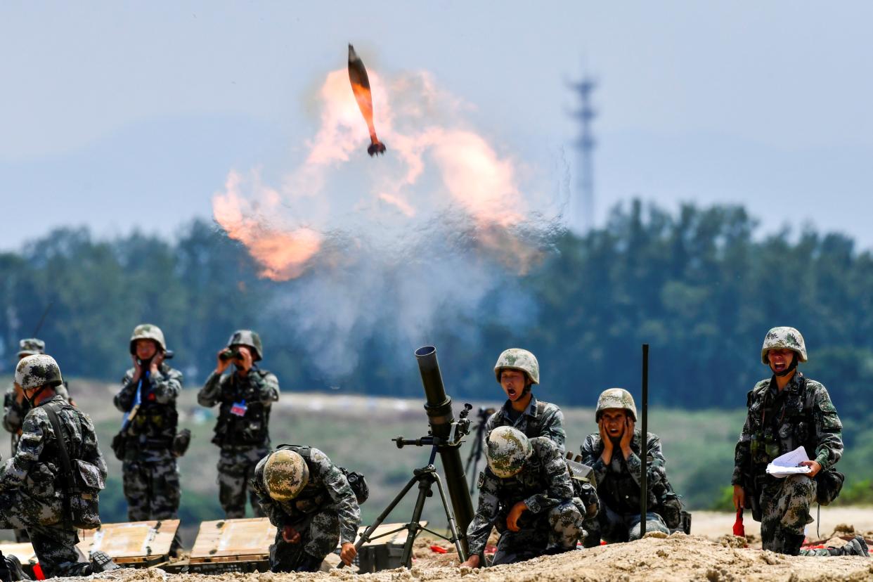 Soldiers of the Chinese People’s Liberation Army fire a mortar during a live-fire military exercise last month (Reuters)