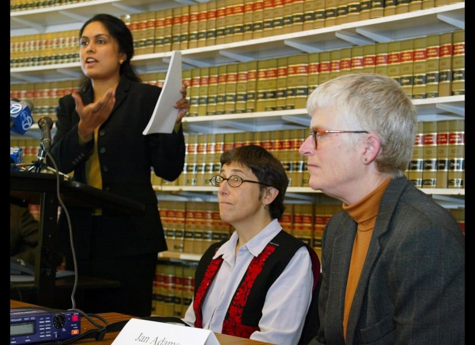 FILE - Jayashri Srikantiah, staff attorney with the ACLU of Northern California, holds up copies of records showing passengers checked on no fly lists from San Francisco International Airport, as plaintiffs Jan Adams, right, and Rebecca Gordon, center, look on during a news conference in San Francisco, in this April 22, 2003 file photo. The American Civil Liberties Union has sued the government on behalf of Americans who believe they're on the no-fly list and have not been able to travel by air for work or to see family. The no-fly list has swelled to 20,000 people before, such as in 2004. At the time, people like the late Sen. Ted Kennedy were getting stopped before flying _ causing constant angst and aggravation for innocent travelers. But much has changed since then. (AP Photo/Eric Risberg, File)