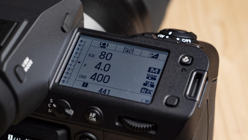 Close up of the Fujifilm GFX100 II 's top LCD displaying camera settings