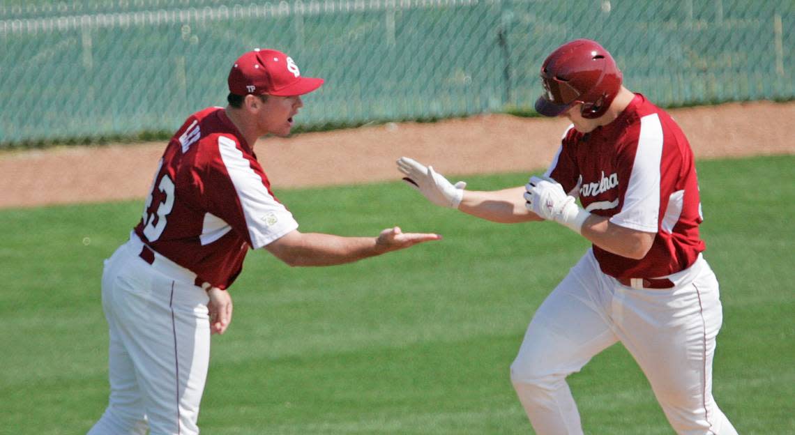 From 2008: Then-USC assistant Monte Lee congratulates Phil Disher after a grand slam against Mississippi State University in a game played at Sarge Frye Field in Columbia.