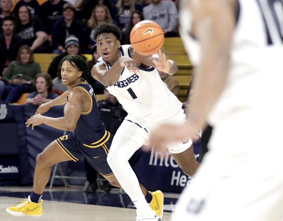 Utah State forward Great Osobor fires off a pass to a teammate during the Aggies’ win over East Tennessee State Dec. 23 at the Spectrum in Logan. | Jeff Hunter