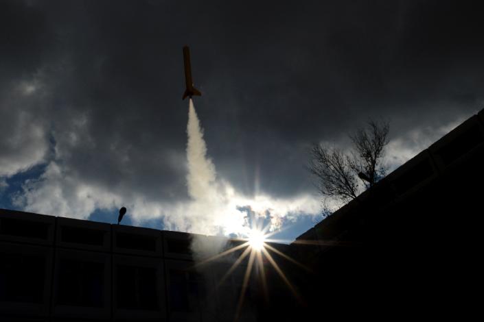 A model of a rocket blasts off from a courtyard of the International Space School in Baikonur, near the Russian-leased cosmodrome, on November 2, 2013 (AFP Photo/Kirill Kudryavtsev)