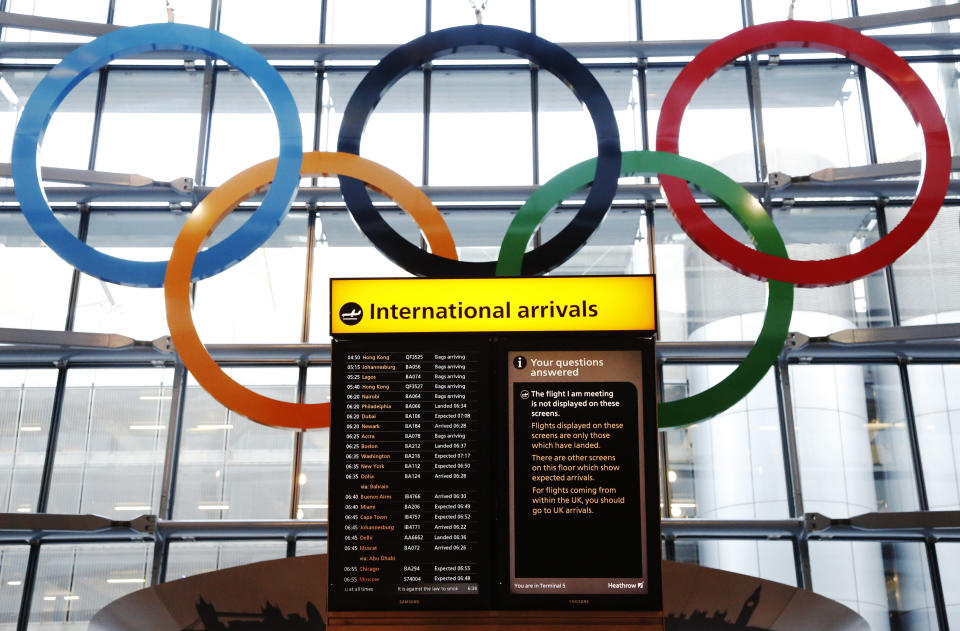 Olympic Rings are revealed during an unveiling ceremony in the Terminal Five arrivals hall at Heathrow Airport, in preparation for the London 2012 Olympic Games in London June 20, 2012. REUTERS/Luke MacGregor (BRITAIN - Tags: TRANSPORT SOCIETY SPORT OLYMPICS)