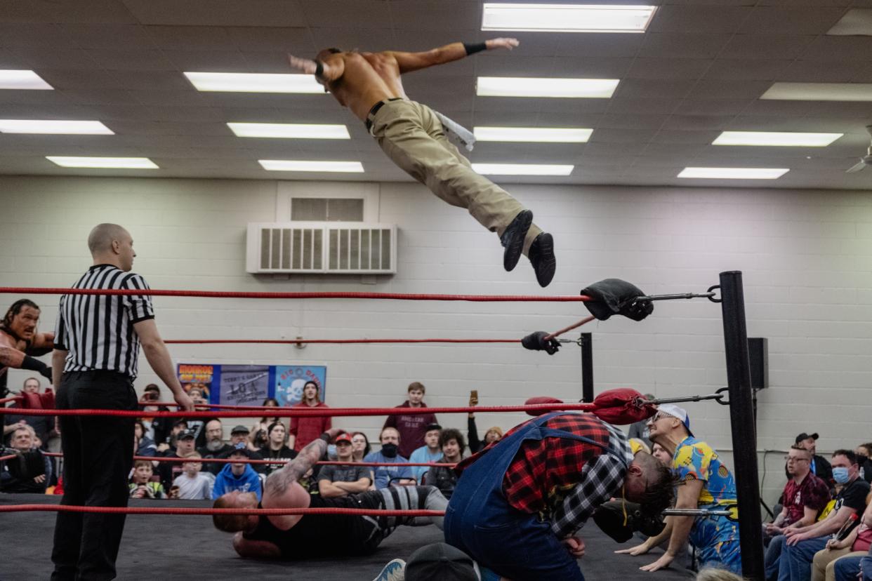 GameChanger Nate Bock flies through the air against former WWE Superstars Rhino and Heath at the Insane Wrestling Revolution event that took place March 24 in Monroe.