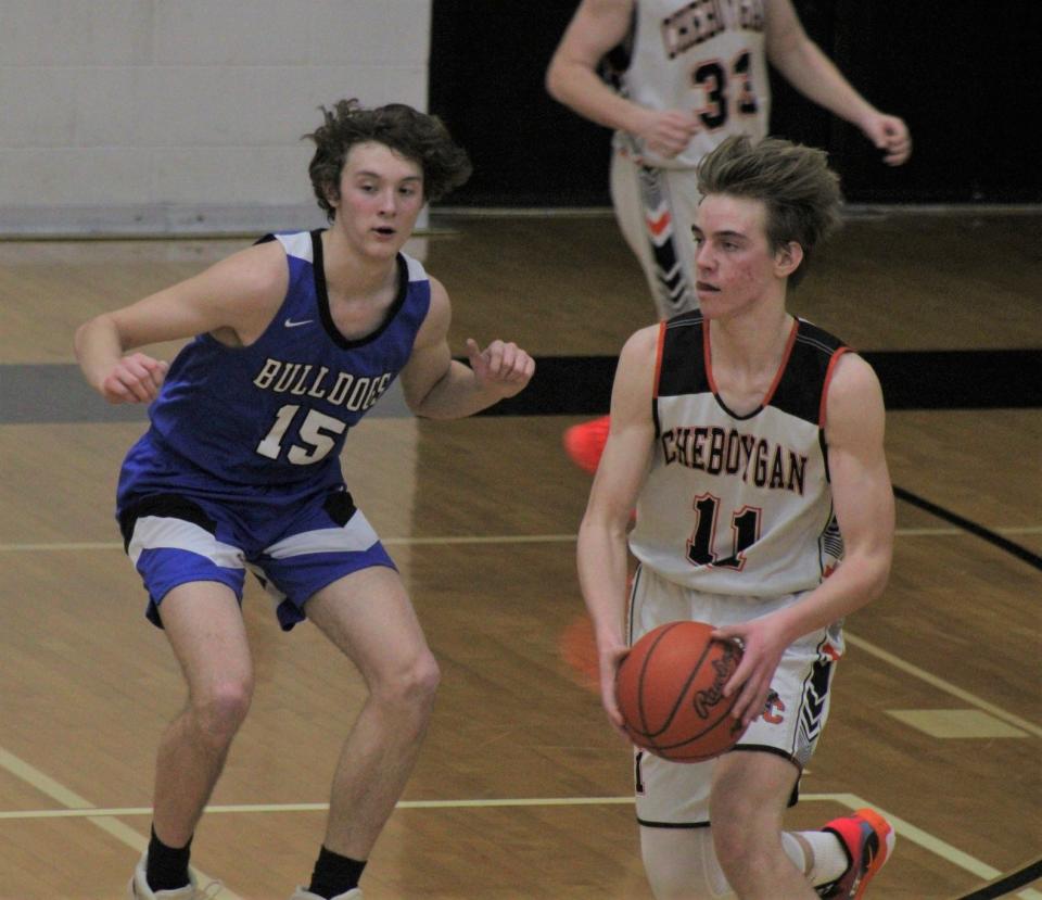 Inland Lakes junior center Sam Schoonmaker (15) defends Cheboygan junior forward Brennen Thater in a recent boys basketball contest. Schoonmaker and the Bulldogs rolled to a dominating victory at JoBurg on Tuesday.