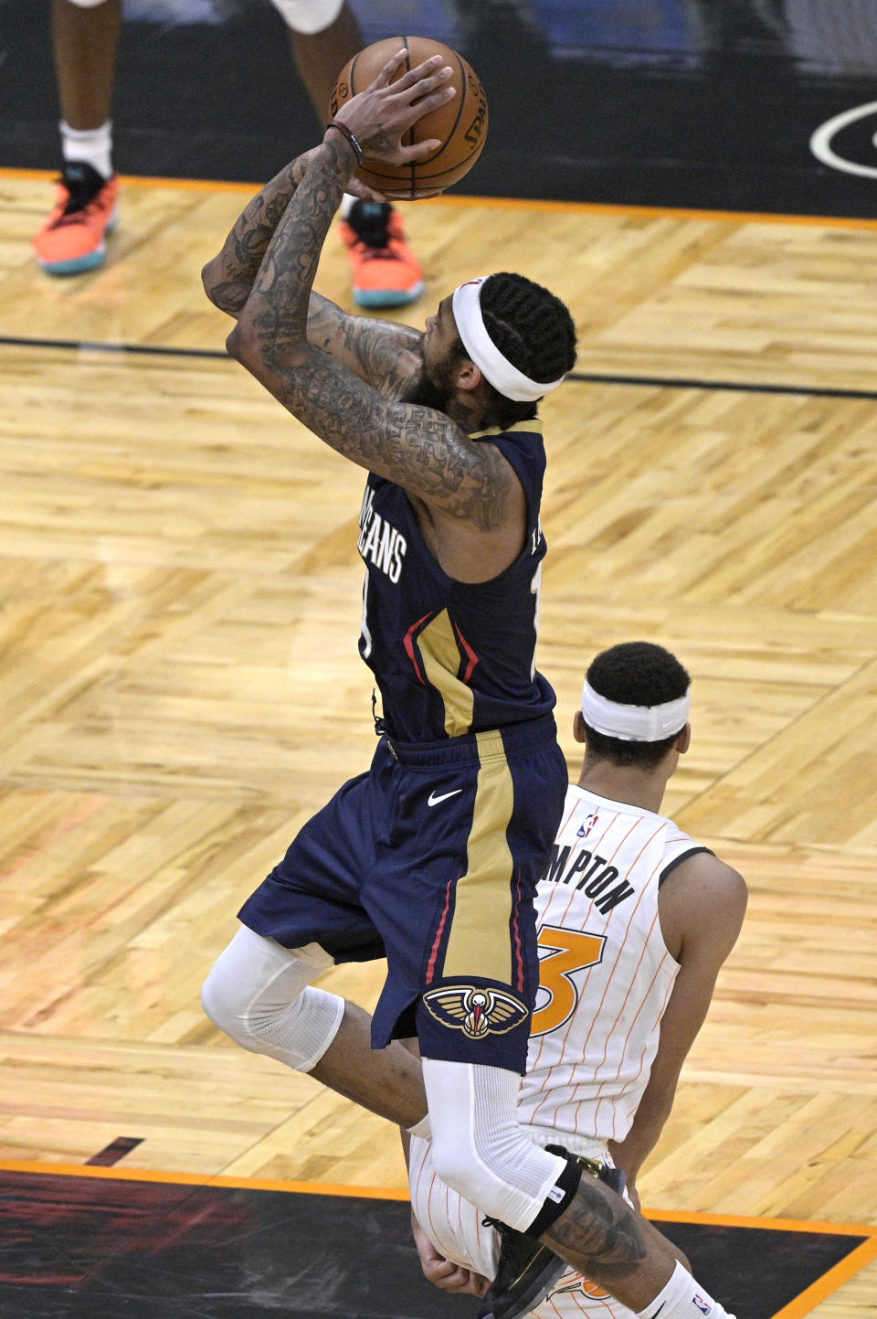 New Orleans Pelicans forward Brandon Ingram goes up for a shot behind Orlando Magic guard R.J. Hampton (13) during the second half of an NBA basketball game Thursday, April 22, 2021, in Orlando, Fla. (AP Photo/Phelan M. Ebenhack)