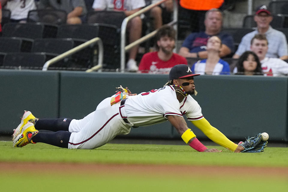 Atlanta Braves right fielder Ronald Acuna Jr. can not reach a ball hit for an RBI double by St. Louis Cardinals' Jordan Walker in the second inning of a baseball game Tuesday, Sept. 5, 2023, in Atlanta. (AP Photo/John Bazemore)