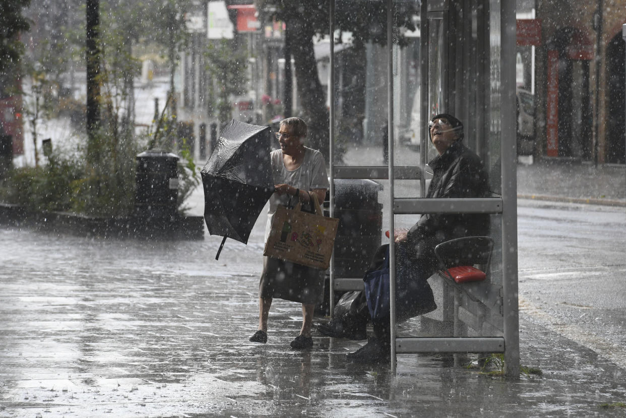 Rain pours, a day after the UK's second hottest day in July ever recorded, in Wanstead in north east London, Friday July 26, 2019. Temperature records that had stood for decades and sometimes hours have toppled across Europe during the second heat wave of the summer. The temperature in Paris hit 42.6 degrees Celsius, (108.7 degrees Fahrenheit) on Thursday, an all-time record.  (Stefan Rousseau/PA via AP)