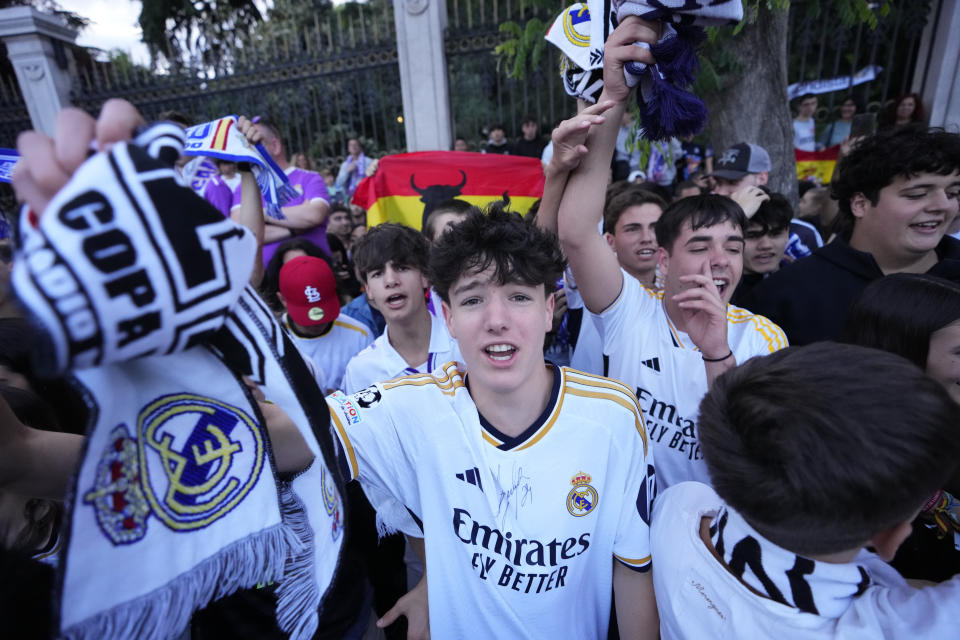 Real Madrid supporters celebrate in Cibeles Square in Madrid after their team clinched the La Liga title, Saturday, May 4, 2024. Real, who had won earlier in the day, clinched the title after Barcelona failed to beat Girona. (AP Photo/Manu Fernandez)