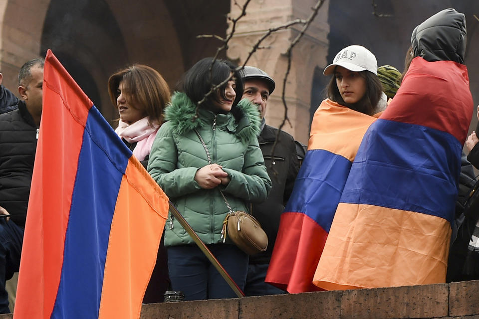 Opposition demonstrators with Armenian national flags gather near the government buildings during a rally to pressure Armenian Prime Minister Nikol Pashinyan to resign in Yerevan, Armenia, Monday, March 1, 2021. Amid escalating political tensions in Armenia, supporters of the country's embattled prime minister and the opposition are staging massive rival rallies in the capital of Yerevan. Prime Minister Nikol Pashinyan has faced opposition demands to resign since he signed a peace deal in November that ended six weeks of intense fighting with Azerbaijan over the Nagorno-Karabakh region. (Lusi Sargsyan/PHOTOLURE via AP)