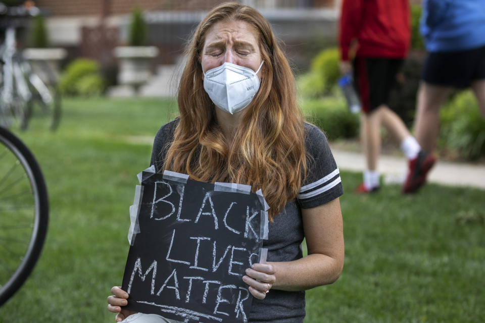 Michelle Dixon, of Washington, weeps during a protest while President Donald Trump visited the Saint John Paul II National Shrine, Tuesday, June 2, 2020, in Washington. "As a parent myself, thinking about all the parents who worry for their children's safety just because of the color of their skin, it's devastating," says Dixon, "it's an unimaginable pain. It's too far of an injustice." Protests continue over the death of George Floyd, who died after being restrained by Minneapolis police officers. (AP Photo/Jacquelyn Martin)