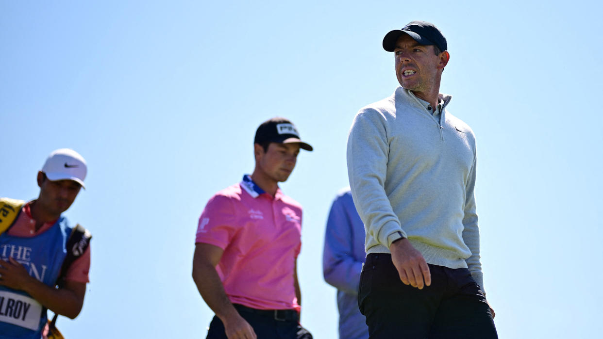  Northern Ireland's Rory McIlroy (R) and Norway's Viktor Hovland (C) leave the 12th tee during a practice round for 151st British Open Golf Championship at Royal Liverpool 