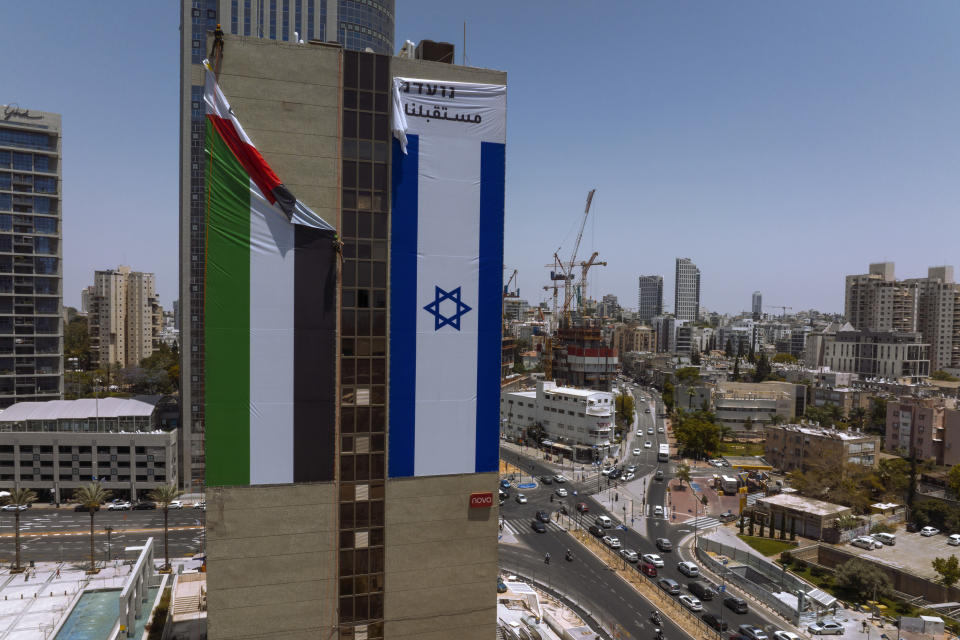 A Palestinian flag is removed from a building by Israeli authorities after being put up by an advocacy group that promotes coexistence between Palestinians and Israelis, in Ramat Gan, Israel, Wednesday, June 1, 2022. In recent weeks, Israeli authorities have gone out of their way to challenge the hoisting of the Palestinian flag. Palestinian citizens of Israel see the campaign against the flag as another affront to their national identity and their rights as a minority in the majority Jewish state.(AP Photo/Oded Balilty, File)