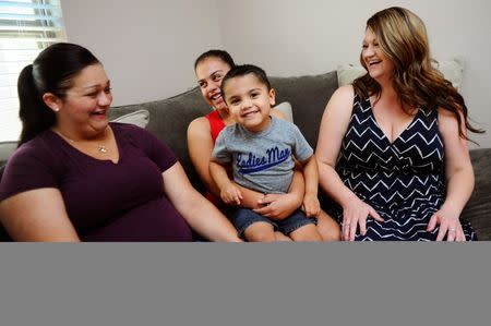 Stephanie Hall (L), sits on the couch with her sister, Crystal Silva (R),and their ten-year-old niece Destini and nephew Kane in El Paso, Texas, U.S. on July 2, 2016. The children's mother, Natalie Silva, contracted Methicillin-resistant Staphylococcus aureus, more commonly known as MRSA, a skin infection that can turn fatal once it enters the bloodstream, when she went to the hospital to deliver Kane. After a 10 month battle with MRSA, Silva died, leaving Hall and the family to raise the two children. REUTERS/Dan Dalstra