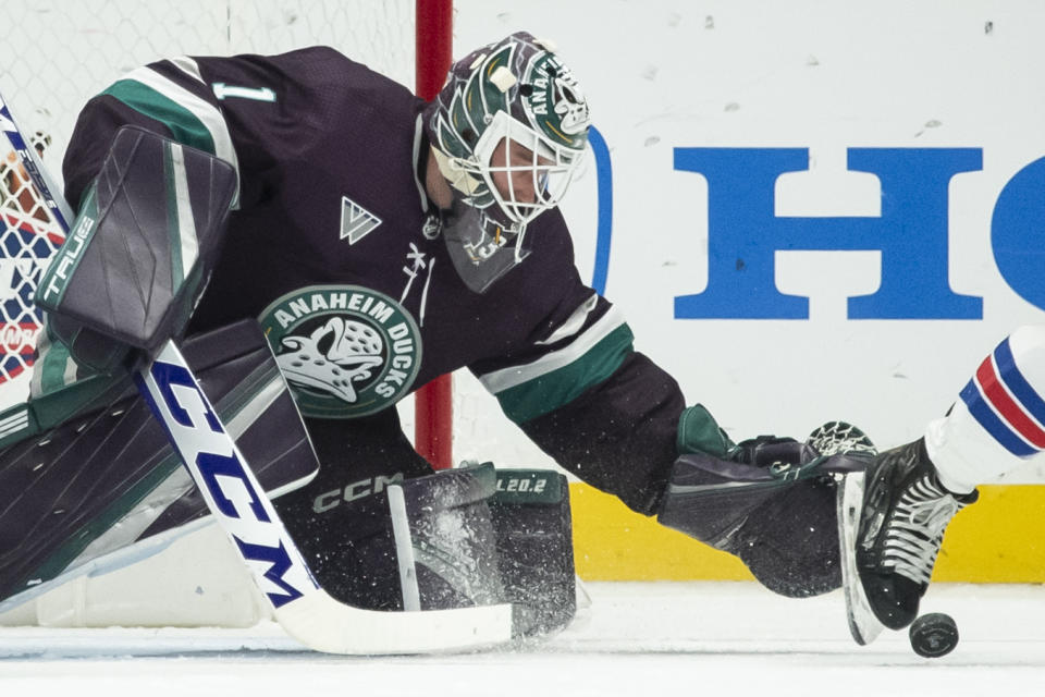 Anaheim Ducks goaltender Lukas Dostal (1) reaches for the puck during the first period of an NHL hockey game against the New York Rangers, Sunday, Jan. 21, 2024, in Anaheim, Calif. (AP Photo/Kyusung Gong)