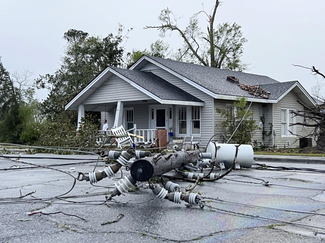 A power pole ripped from its location lies on East College street in Pembroke, Ga., after a storm damaged several homes and the Bryan County Courthouse, Tuesday, April 5, 2022. Pembroke is 30 miles from Savannah, Ga. (AP Photo/Lewis M. Levine)