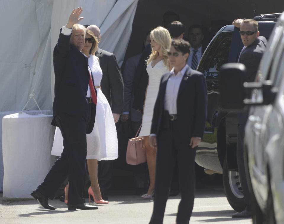 President Donald Trump, accompanied by first lady Melania Trump waves to onlookers as he enters Episcopal Church of Bethesda-by-the-Sea in Palm Beach, Fla., for an Easter Service, Sunday, April 16, 2017. (Joe Cavaretta/South Florida Sun-Sentinel via AP)