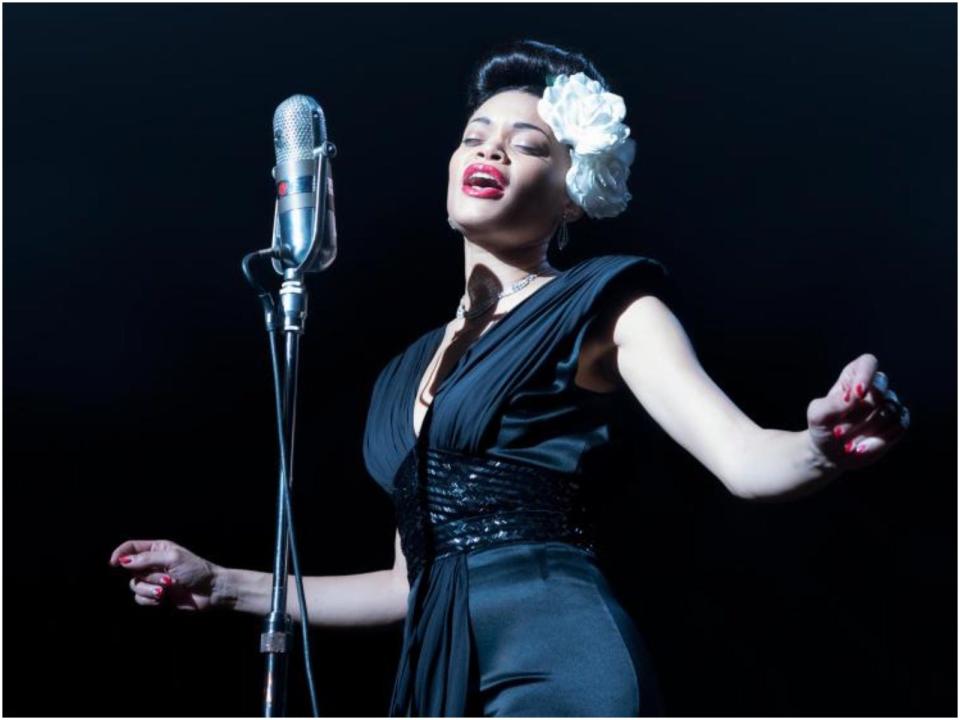 Andra Day as Billie Holiday singing into microphone