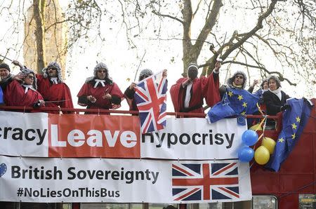 Protesters wearing judges' wigs and robes ride an open top bus past the Supreme Court ahead of the challenge against a court ruling that Theresa May's government requires parliamentary approval to start the process of leaving the European Union, in Parliament Square, central London, Britain December 5, 2016. REUTERS/Toby Melville