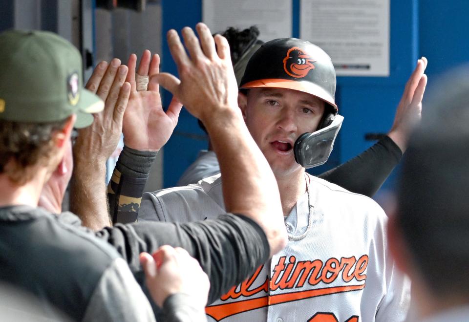 May 21, 2023; Toronto, Ontario, CAN; Baltimore Orioles left fielder Austin Hays (21) celebrates with teammates in the dugout after scoring against the Toronto Blue Jays in the 11th inning at Rogers Centre.