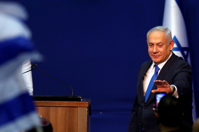 Israeli Prime Minister Benjamin Netanyahu reacts upon his arrival to address his supporters following the announcement of exit polls in Israel's election at his Likud party headquarters in Tel Aviv