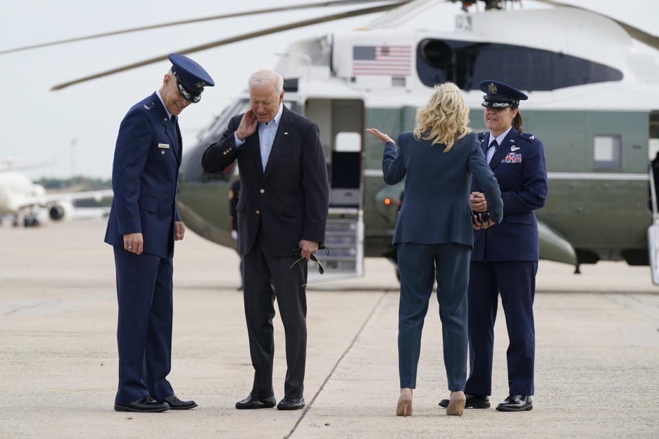 President Joe Biden brushes a cicada from his neck as he and first lady Jill Biden board Air Force One, Wednesday, June 9, 2021, at Andrews Air Force Base, Md. Biden is embarking on the first overseas trip of his term, and is eager to reassert the United States on the world stage, steadying European allies deeply shaken by his predecessor and pushing democracy as the only bulwark to the rising forces of authoritarianism. (AP Photo/Patrick Semansky)