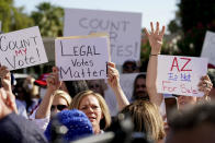 Protesters hold signs during an Arizona Republican Party news conference, Thursday, Nov. 5, 2020, in Phoenix. (AP Photo/Matt York)