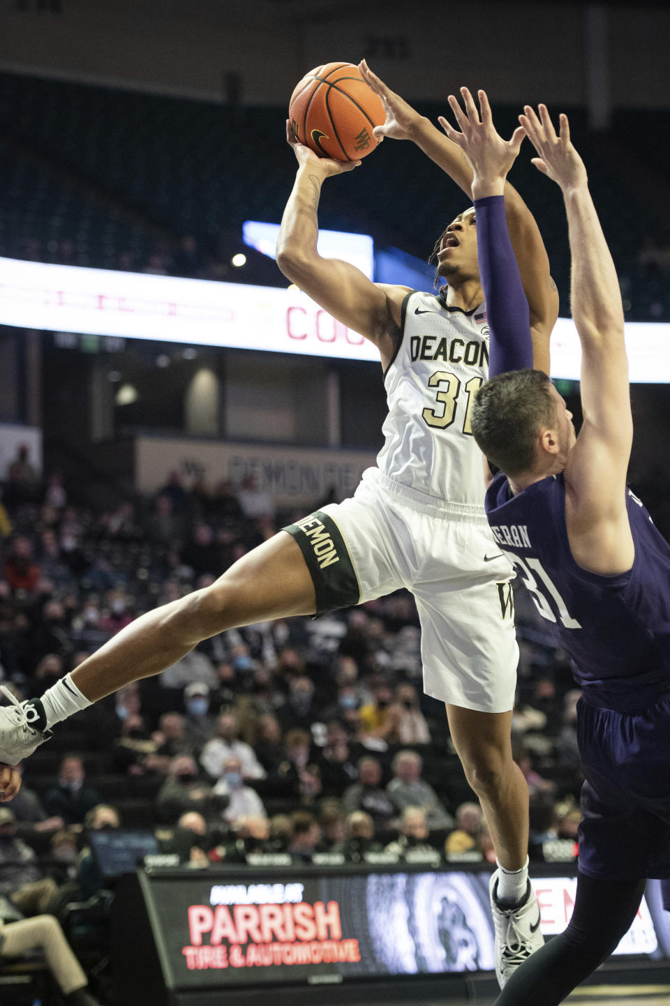 Wake Forest guard Alondes Williams (31) shoots over Northwestern forward Robbie Beran (31) in the first half of an NCAA college basketball game on Tuesday, Nov. 30, 2021, at the Joel Coliseum in Winston-Salem, N.C. (Allison Lee Isley/The Winston-Salem Journal via AP)